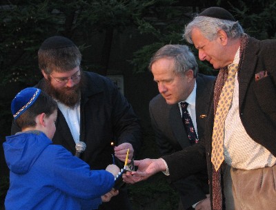 Left to right: Aaron Hagler (son of congregants Rebecca & Mitchell Hagler), Rabbi Rafe Konikov, Southampton Village Mayor Joseph Romanosky, and congregant Arnold Paster at the Southampton Jewish Center's 2003 public menorah lighting in Southampton Village.